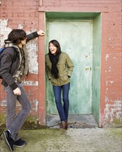 Couple talking in urban doorway. Date : 2008