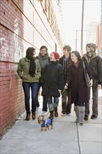 Group of friends walking on urban sidewalk. Date : 2008