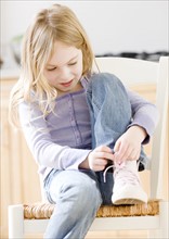 Close up of girl tying shoe. Date : 2008