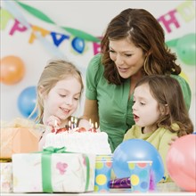 Girl celebrating birthday with mother and sister. Date : 2008