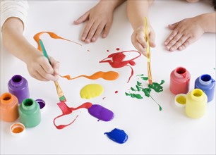 Children painting on table. Date : 2008