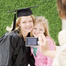 Graduate mother and daughter having photograph taken. Date : 2008