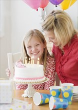 Girl celebrating birthday with mother. Date : 2008