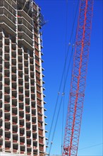 Low angle view of crane and apartment building, New York City, New York, United States. Date : 2008
