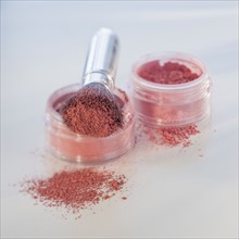 Close up of mineral cosmetics and brush.