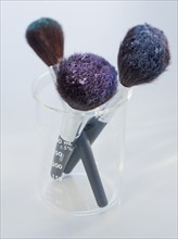 Cosmetic brushes in beaker.