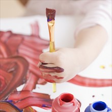 Child holding paintbrush. Date : 2008