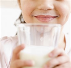 Girl holding glass of milk. Date : 2008