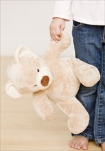 Close up of child holding teddy bear. Date : 2008