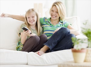 Mother and daughter watching television. Date : 2008
