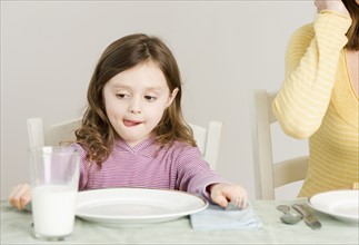 Girl sitting at dinner table. Date : 2008