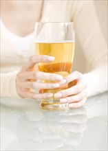 Woman holding glass of beer. Date : 2008