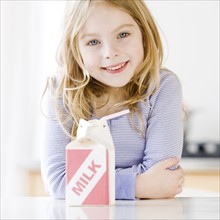 Girl next to carton of milk. Date : 2008