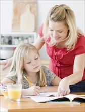 Mother helping daughter with homework. Date : 2008