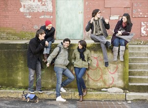 Group of friends sitting in urban scene. Date : 2008