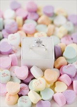 Engagement ring in box on candy hearts. Date : 2008