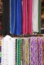 Bead necklaces hanging on rack, French Quarter, New Orleans, Louisiana, United States. Date : 2008