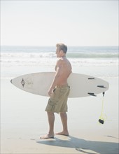 Man holding surfboard. Date : 2008