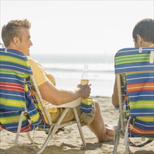 Two men sitting in beach chairs. Date : 2008
