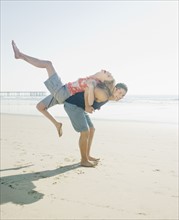 Couple playing around on beach. Date : 2008