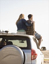 Couple sitting on top of car. Date : 2008