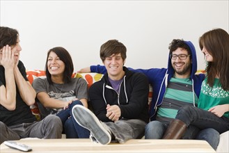 Group of friends sitting on sofa. Date : 2008