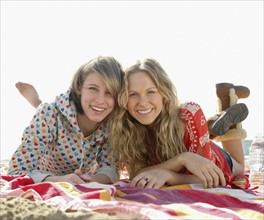 Two young women laying on beach. Date : 2008