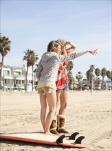 Two young women standing on beach. Date : 2008