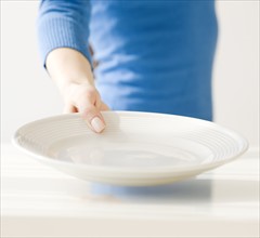 Woman holding empty dish. Date : 2008