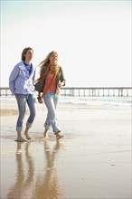 Two women walking on beach. Date : 2008