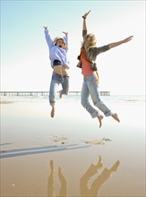Two women jumping on beach. Date : 2008