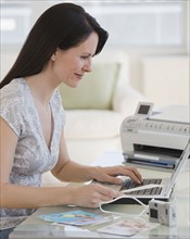 Woman typing on laptop.