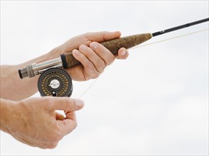 Close up of man fishing rod.