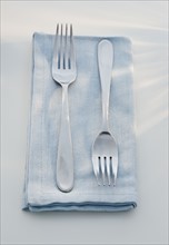 Close up of forks on napkin.