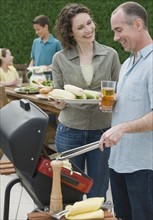 Family with two children barbecuing.