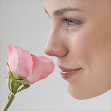 Woman smelling flower.