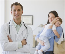 Male doctor in front of mother and son.