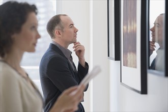 Couple looking at art in art gallery.