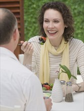 Couple eating outdoors.