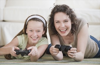 Mother and daughter playing video games.