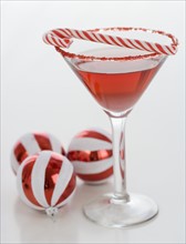 Cocktail with candy cane and Christmas ornaments. Date : 2008