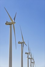 Low angle view of wind turbines.