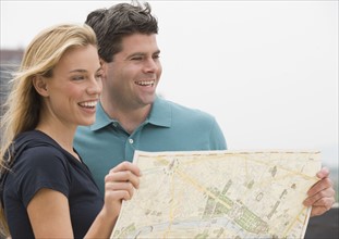 Couple holding map.