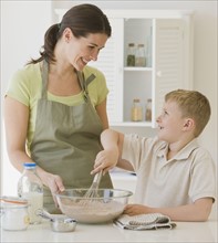 Mother and son making batter.