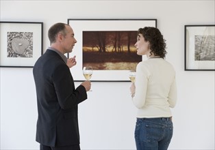 Couple discussing art at art gallery.