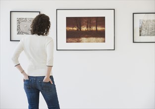 Woman looking at art in art gallery.