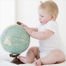 Baby looking at globe. Date : 2008