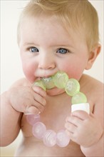 Baby biting on teething ring. Date : 2008