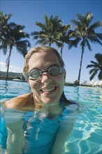 Woman wearing goggles in swimming pool. Date : 2008