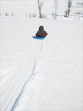 Boy riding on sled. Date : 2008